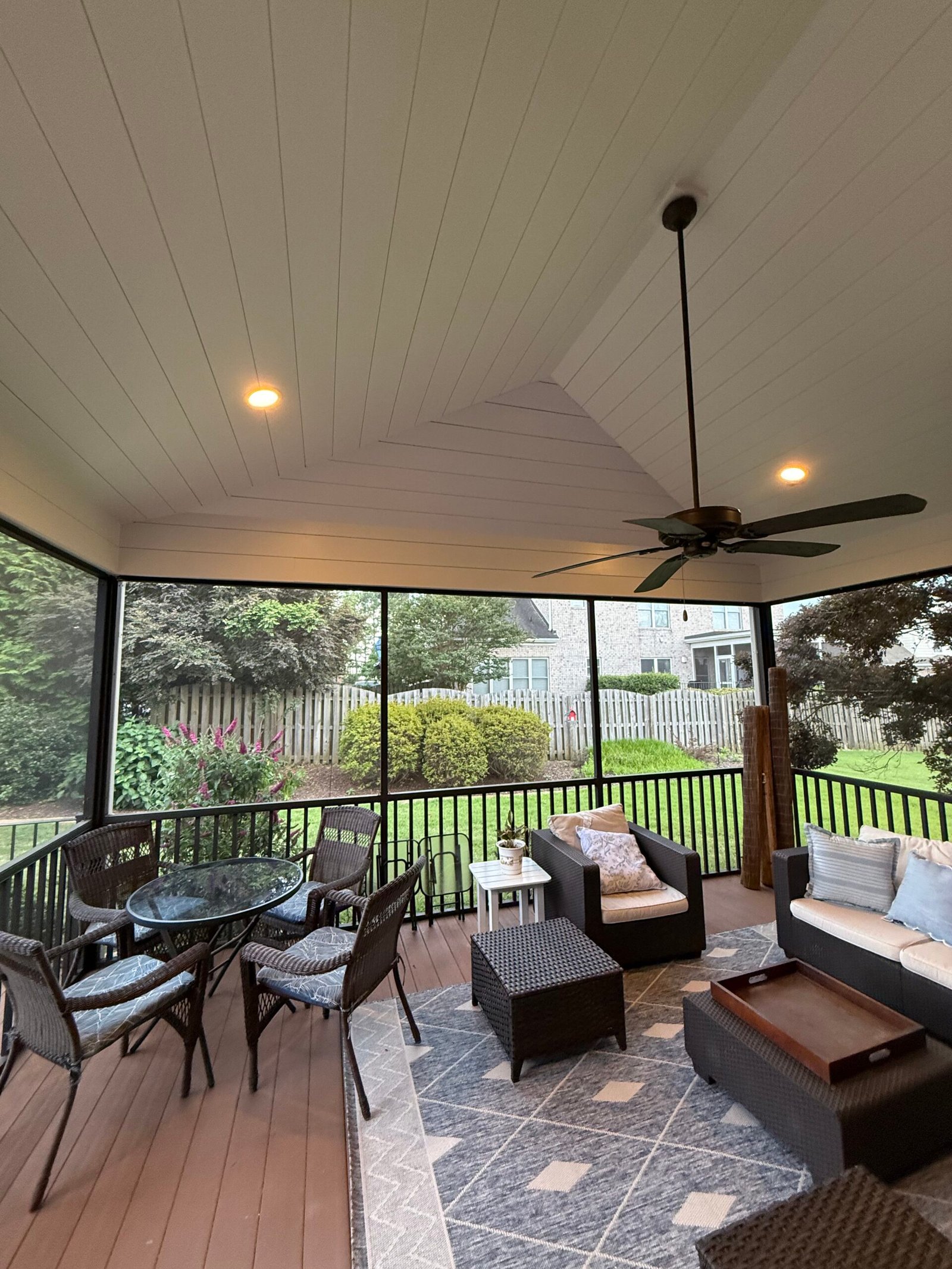 IAC Construction screened-in porch with ceiling fan and backyard view